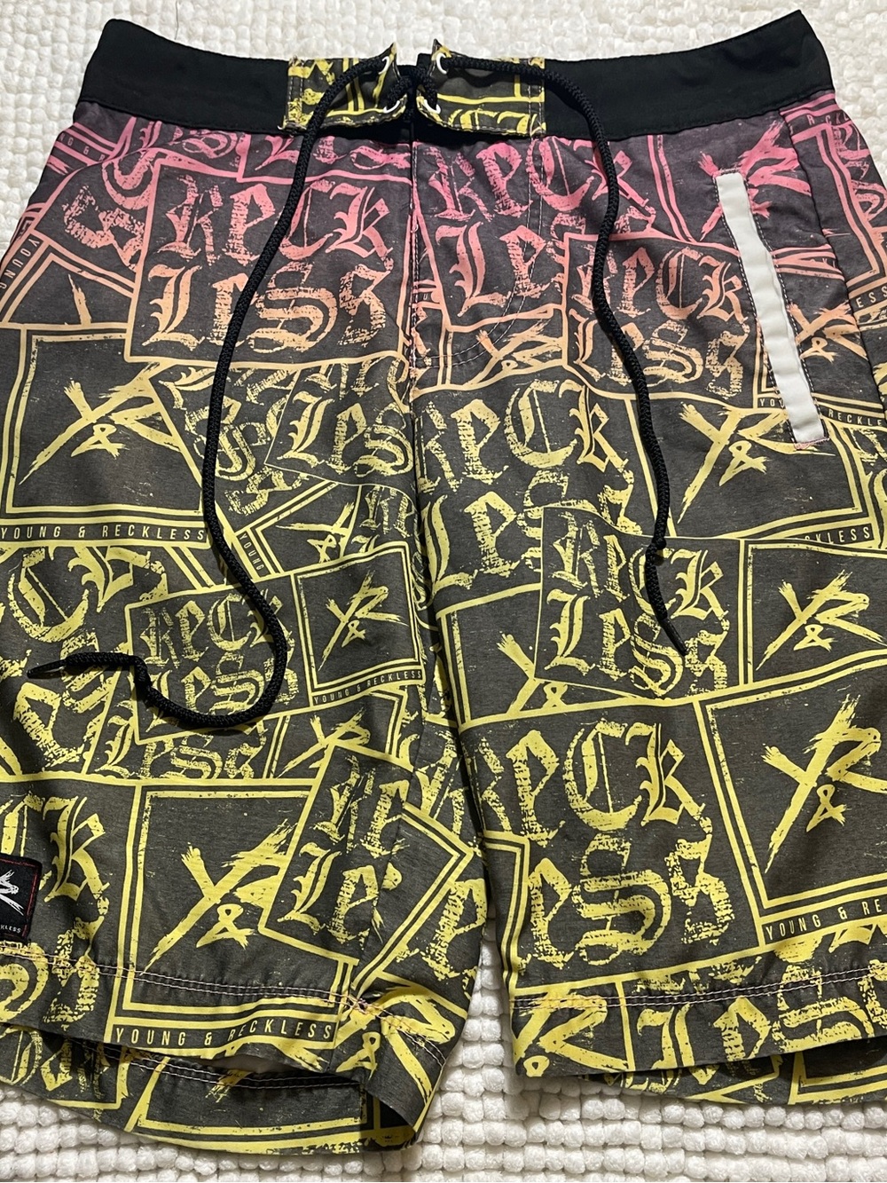 Young & Reckless Board Shorts, Black with Yellow and Pink Gradient Logo